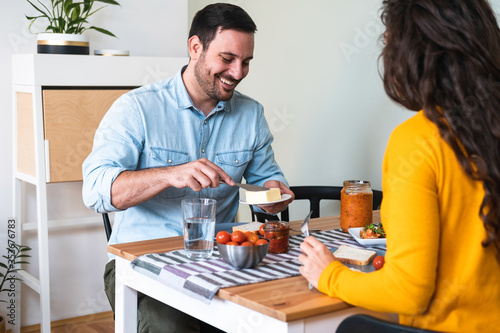 Happy couple eating breakfast together stock photo
