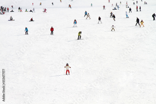 High angle view of people playing ski on a slope, people skiing in a ski resort