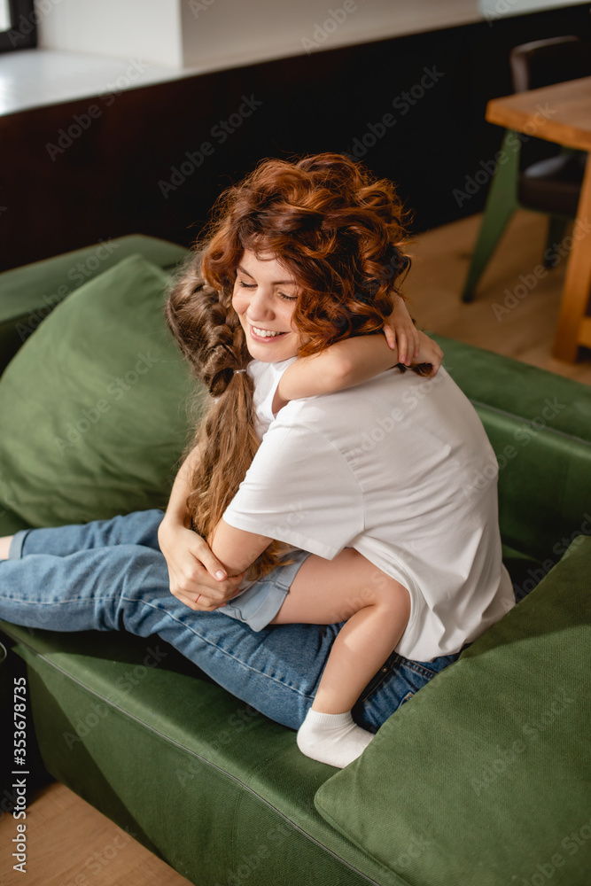 cute daughter hugging happy and curly mother cute daughter hugging happy and curly mother