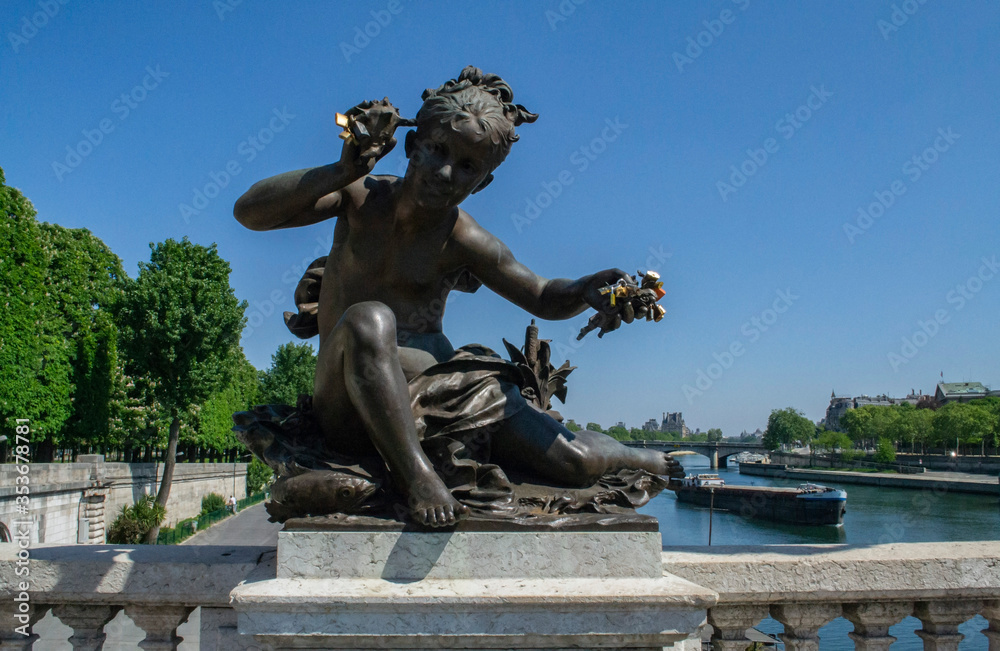 beautiful decorative statues on the bridge of Alexander III in Paris