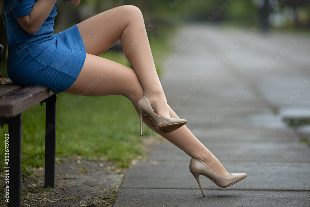 Perfect legs in pantyhose and high heels shoes at the city square.  Stock-Foto | Adobe Stock