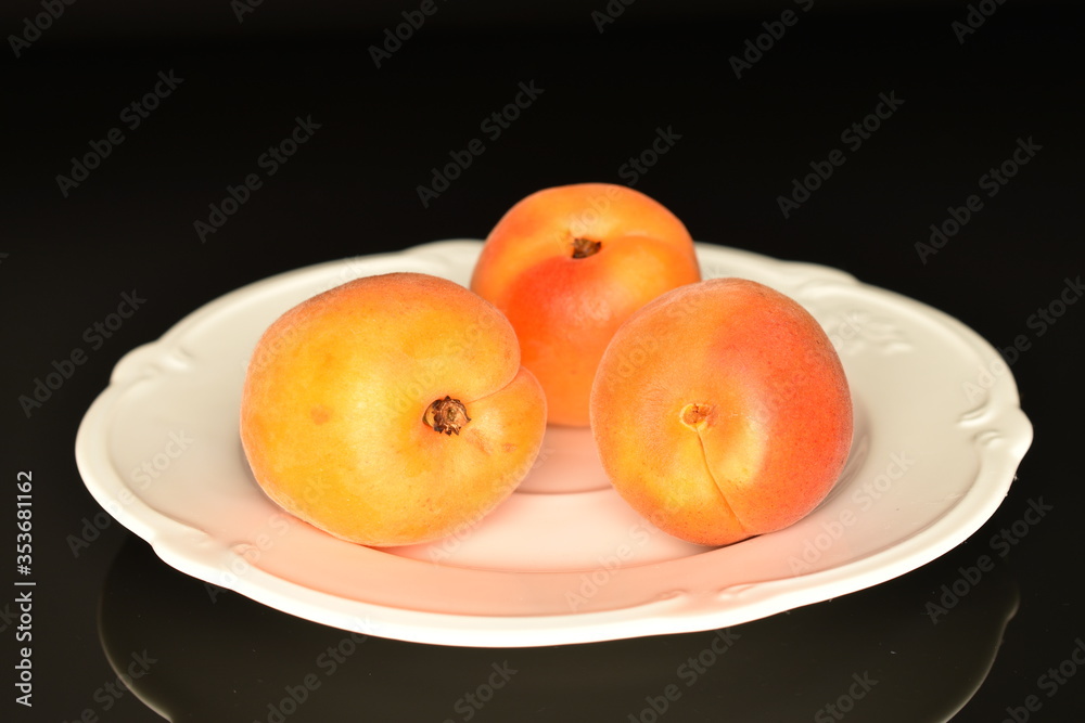 Ripe sweet, organic apricots, close-up, on a black background.