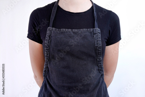 Fototapete young woman with dar apron