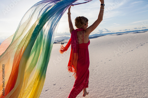 adult woman running with rainbow streamer in sand dunes, White Sands Nat'l Monument photo