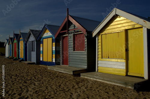 Small bathing houses on sandy beach at Brighton Beach, Australia