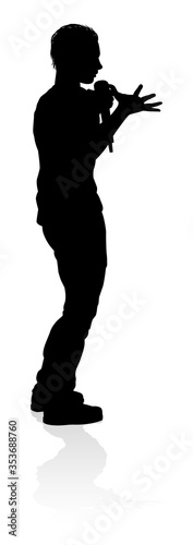 A singer pop, country music, rock star or hiphop rapper artist vocalist singing in silhouette
