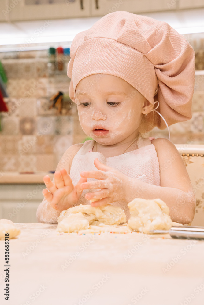 Little girl cooks at home in the kitchen Little girl cooks at home in the kitchen