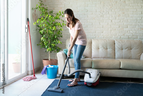 Woman cleaning her house with a vacuum