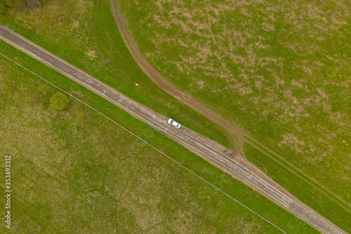 High Angle Aerial View of Rural road with car between green fields, Moscow area, Russia
