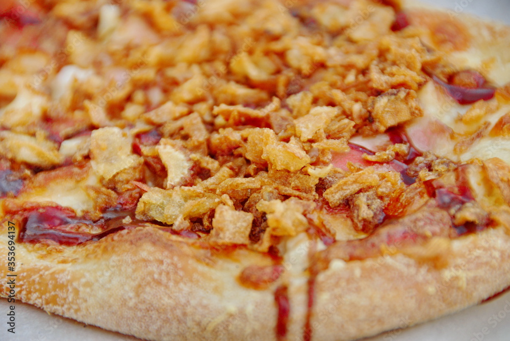 Rustic pizza with bacon, cheese, smoked home-made sausage, paprika, fried onions and ketchup Rustic pizza with bacon, cheese, smoked home-made sausage, paprika, fried onions and ketchup