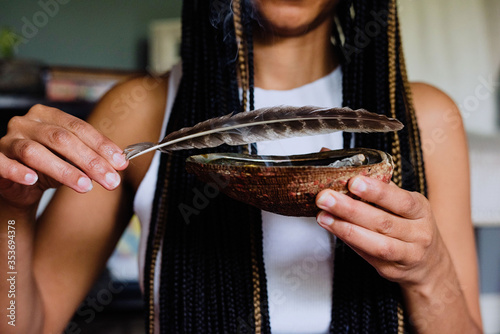 Woman burning sage to promote health, clarity and healing at home for relaxation