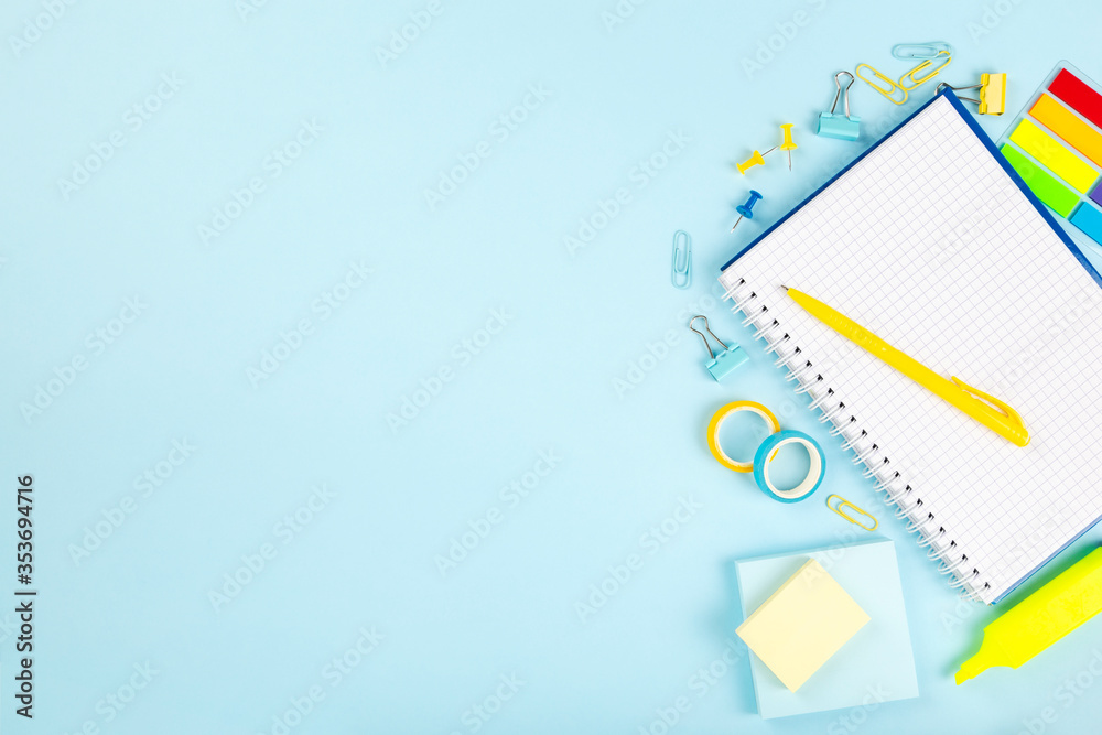 School office supplies on blue background. Back to school concept. Top view. Copy space School office supplies on blue background. Back to school concept. Top view. Copy space