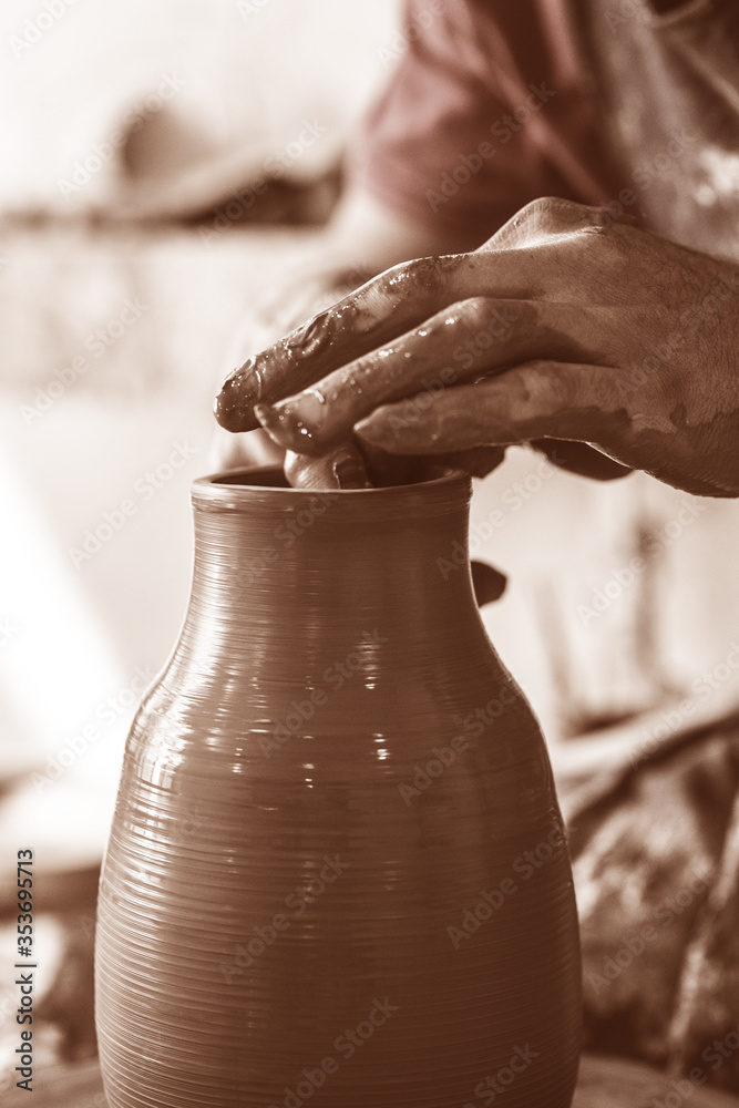 Potter hands making in clay on pottery wheel. Potter makes on the pottery wheel Potter hands making in clay on pottery wheel. Potter makes on the pottery wheel