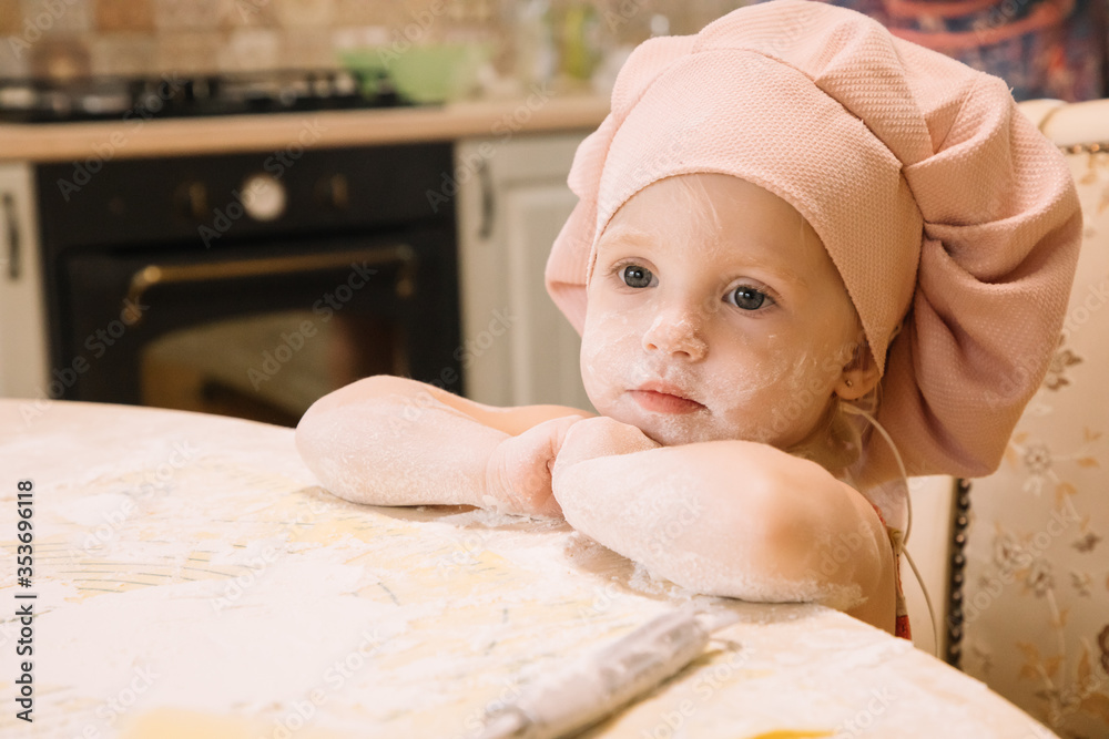 Little girl cooks at home in the kitchen Little girl cooks at home in the kitchen