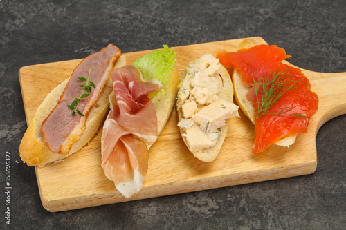 Tapas - bruschetta with prosciutto  salmon  duck and gorgonzola