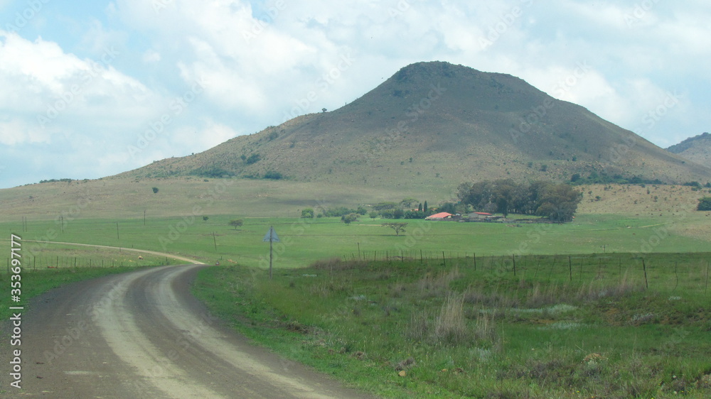 Scenic farmland in KZN, South Africa near Glencoe, in the summertime with a partly cloudy sky.