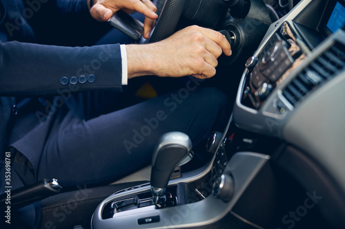 Man in suit going in car alone