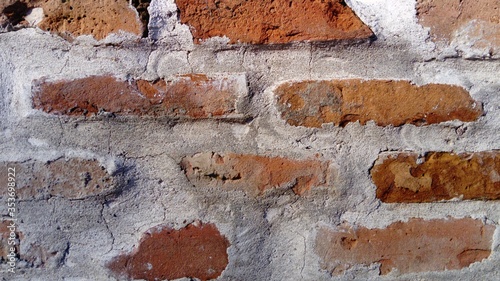 Old roman brick. The restored wall of the building of the Roman conquerors. Warm brown-red shades of uneven bricks. Archaeological site in the city of Sremska Mitrovica, Serbia. photo