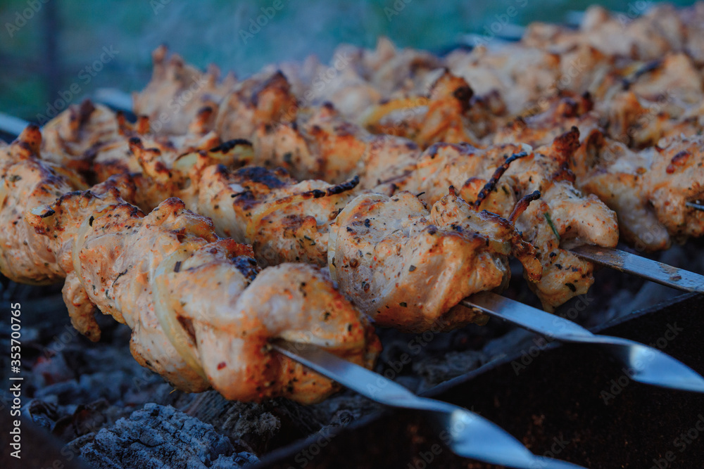 Fry kebabs mounted on skewers. Below are hot charcoals. Fry kebabs mounted on skewers. Below are hot charcoals.