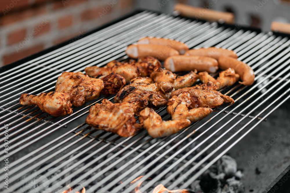 Grilled food. Grilled pork sausage, bacon and vegetables on the grill plate, top view, outdoor. Barbecue, bbq Grilled food. Grilled pork sausage, bacon and vegetables on the grill plate, top view, outdoor. Barbecue, bbq