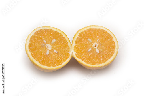 Orange fruit with orange slices and leaves isolated on white background.