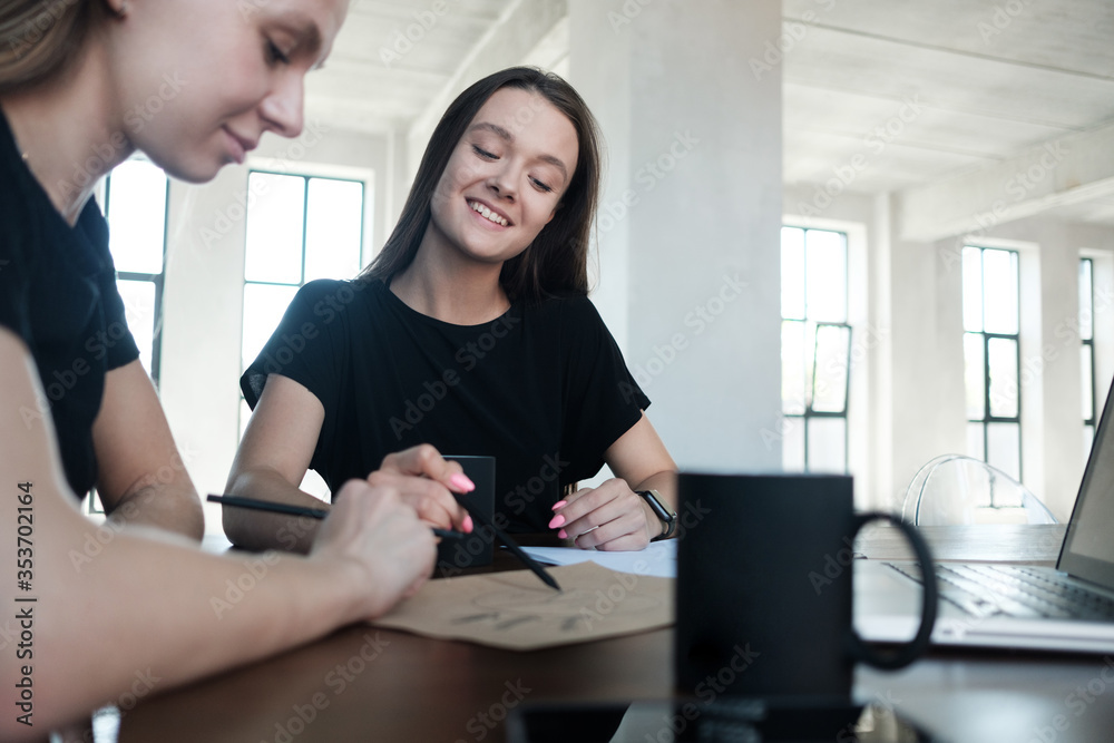 Image of two young business woman writs work plan at meeting. Image of two young business woman writs work plan at meeting.