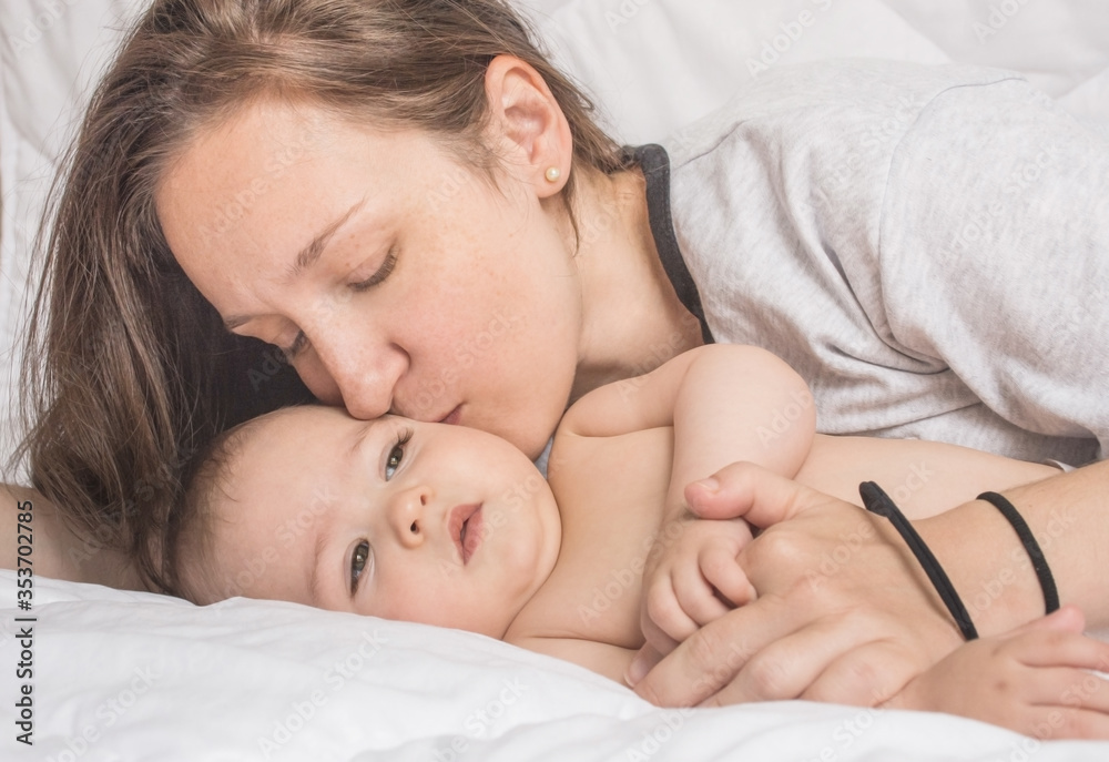 Happy mother playing with sweet little baby boy, white background Happy mother playing with sweet little baby boy, white background