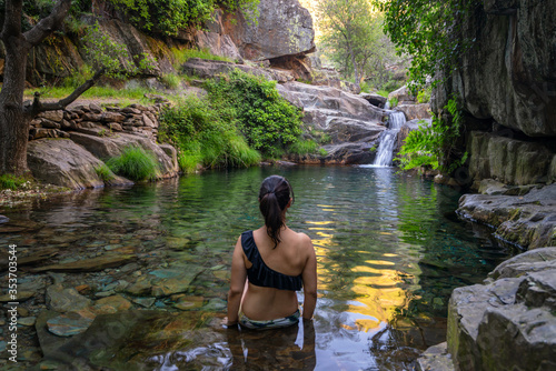 Woman in Drave waterfall cascata in Arouca Serra da Freita, Portugal photo