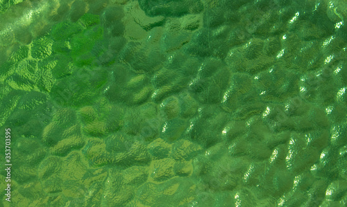 Abstract green glass close-up . Bubble glass surface