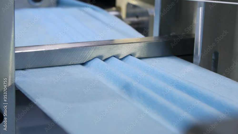 production line makes gofferings on fabric strip for masks production line makes gofferings on fabric strip for masks