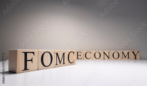 FOMC Meeting Minutes word over Candlestick chart Forex background. Close up.