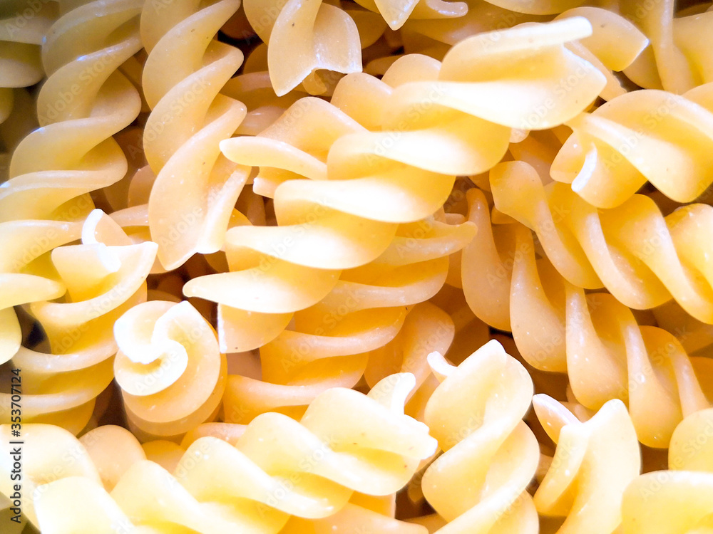 Close up of uncooked fusilli pasta. Food background. Top view, from above. Close up of uncooked fusilli pasta. Food background. Top view, from above.