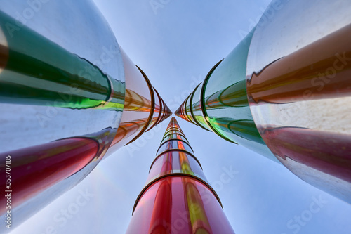 Fotografie 3 colorful masts protrude into the blue cloudy sky, deep perspective, ultra wide angle