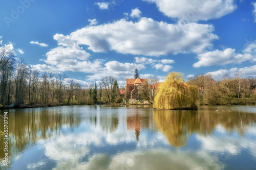 An old monastery in an idyllic atmosphere on a lake in sunshine © Tobias