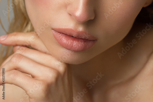 Sexual full lips. Natural gloss of lips and woman's skin. The mouth is closed. Increase in lips, cosmetology. Natural lips. Great summer mood with open eyes. fashion jewelry. Pink lip gloss