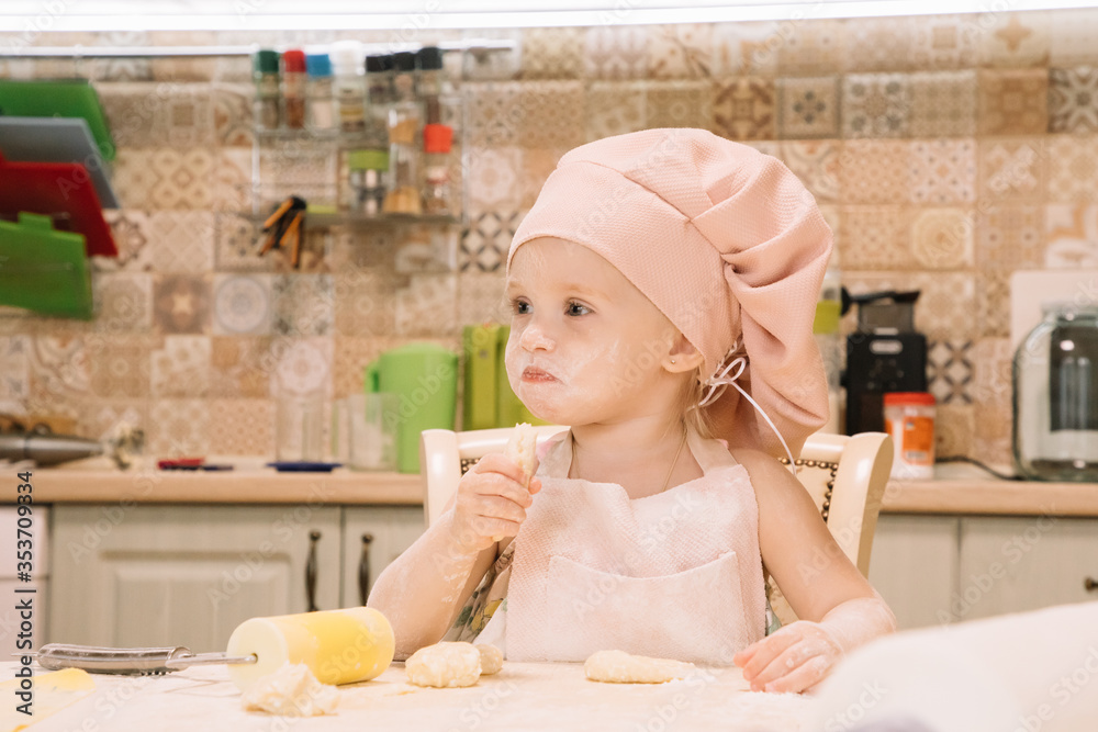 Little girl cooks at home in the kitchen Little girl cooks at home in the kitchen
