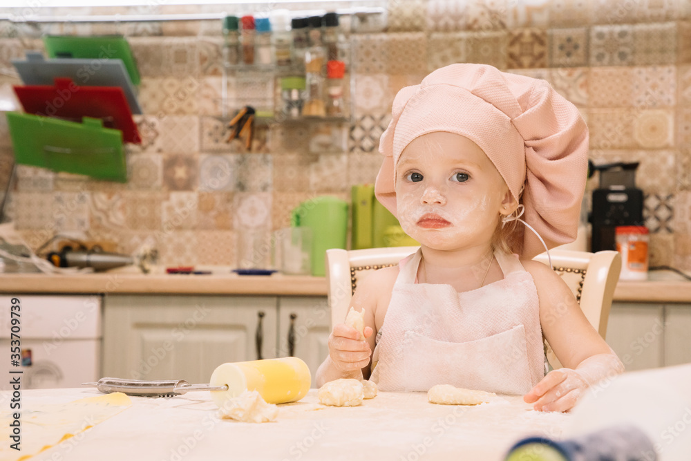 Little girl cooks at home in the kitchen Little girl cooks at home in the kitchen
