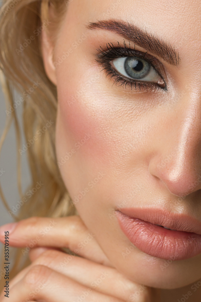 Half a beauty portrait with beautiful fashionable evening make-up, pink liner on eyes and extremely long eyelashes. natural lipstick on the lips. Cosmetology and spa facial skin care Half a beauty portrait with beautiful fashionable evening make-up, pink liner on eyes and extremely long eyelashes. natural lipstick on the lips. Cosmetology and spa facial skin care