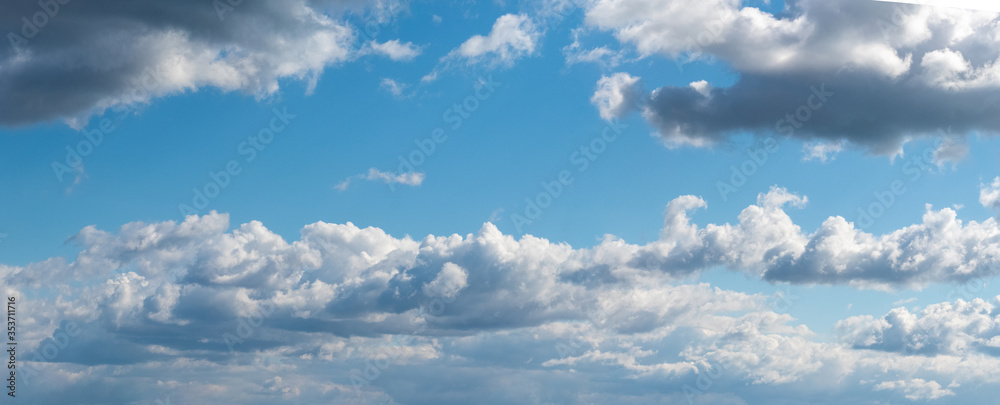 Panorama of blue sky with white curly clouds Panorama of blue sky with white curly clouds