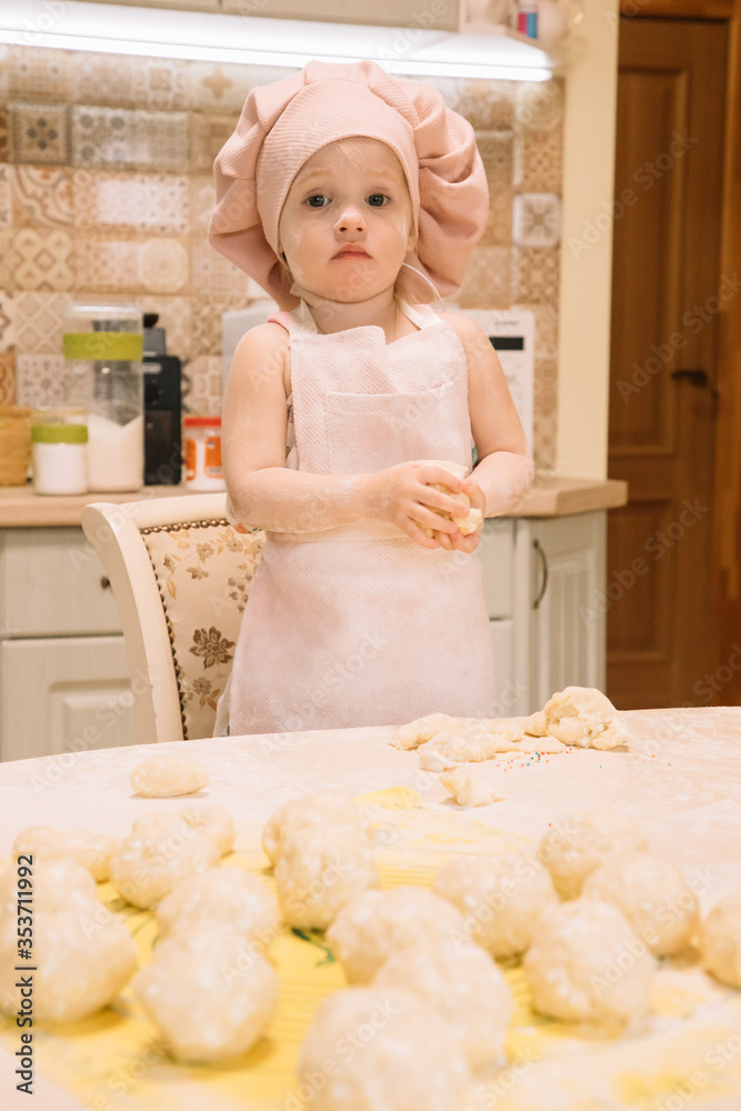 Little girl cooks at home in the kitchen Little girl cooks at home in the kitchen