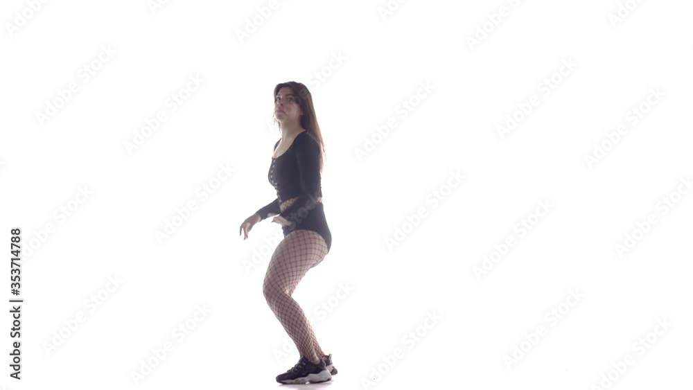 young sensual beautiful woman dancer with long hair in fishnet tights and shorts vigorously dancing dancehall twerk, street modern dance, long shot, isolated young sensual beautiful woman dancer with long hair in fishnet tights and shorts vigorously dancing dancehall twerk, street modern dance, long shot, isolated