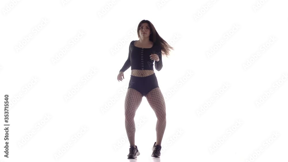 young sensual beautiful woman dancer with long hair in fishnet tights and shorts vigorously dancing dancehall twerk, street modern dance, long shot, isolated young sensual beautiful woman dancer with long hair in fishnet tights and shorts vigorously dancing dancehall twerk, street modern dance, long shot, isolated
