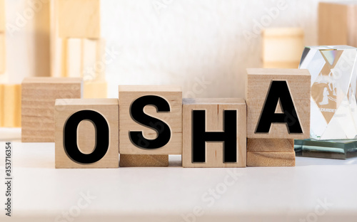 OSHA Occupational Safety and Health Administration. Safety first work background on a wooden cubes.