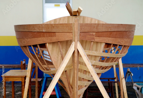 A small wooden boat design being built.