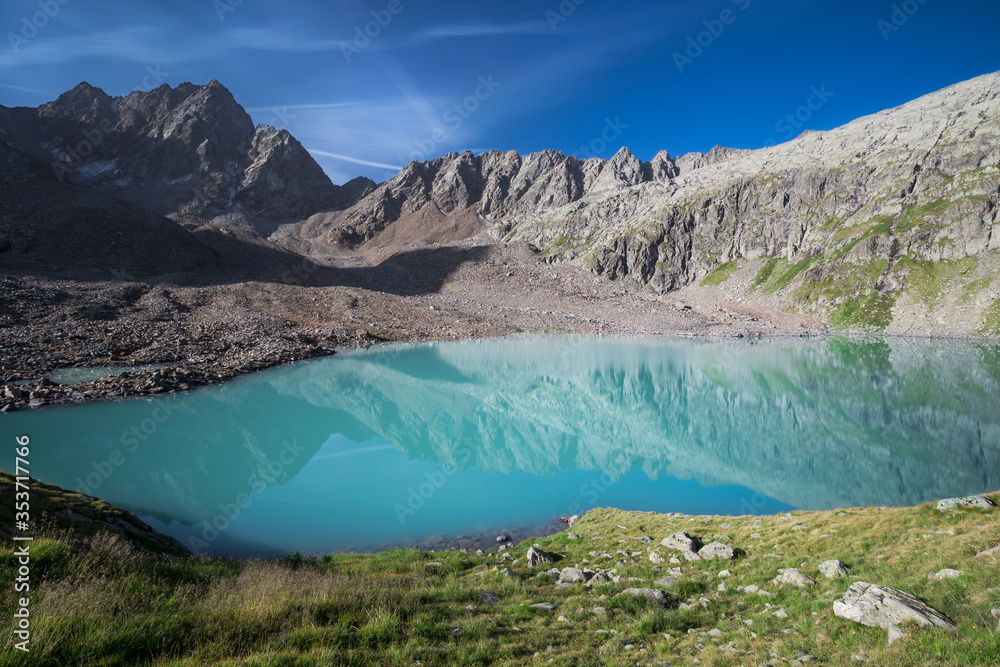 Turquoise lake Gradensee at Nossberger Hut, mountains and reflection on water surface, in Gradental in national park Hohe Tauern, Austria. Turquoise lake Gradensee at Nossberger Hut, mountains and reflection on water surface, in Gradental in national park Hohe Tauern, Austria.
