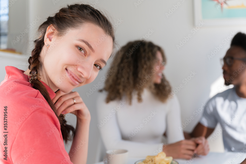 Woman smiling while hanging out with friends Woman smiling while hanging out with friends