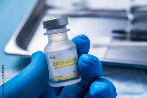 Close-up†of gloved hand holding vial of†Coronavirus†vaccine