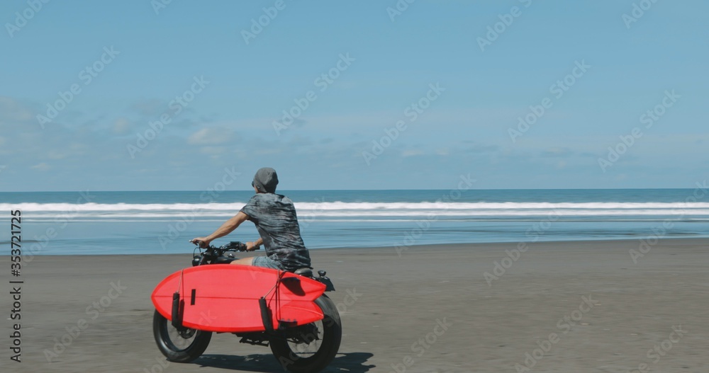 Motorcyclist driving his motorbike on the beach Motorcyclist driving his motorbike on the beach
