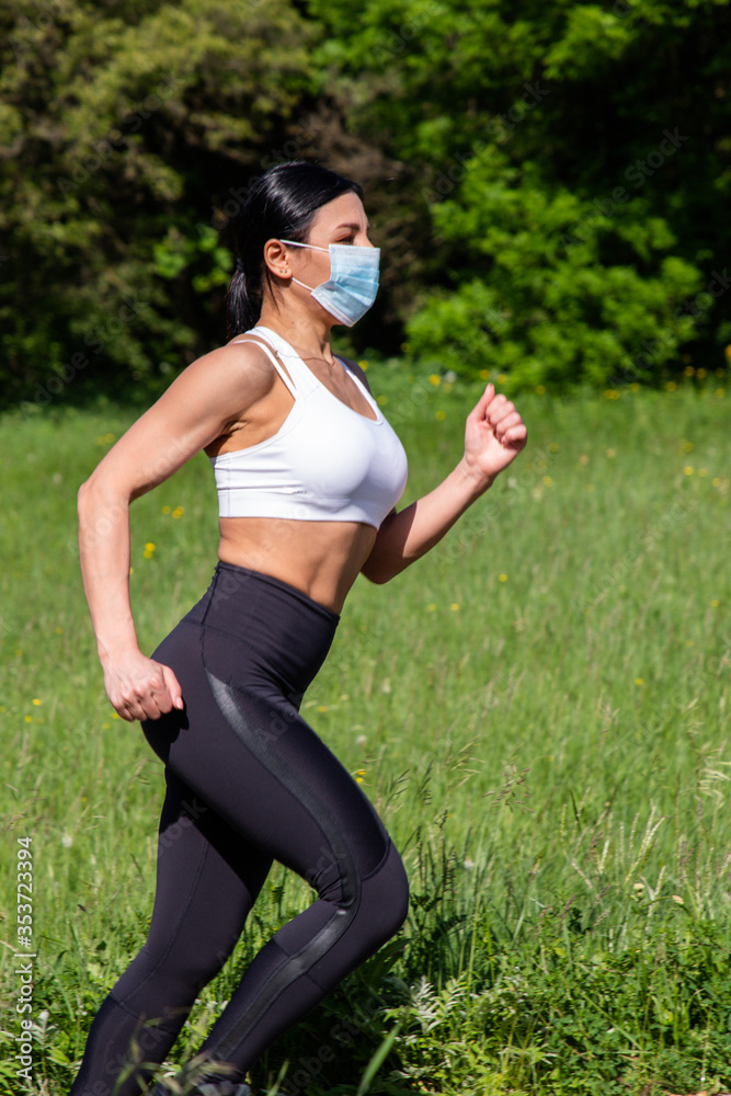 The girl in the mask goes in for sports in the park. The girl in the mask goes in for sports in the park.