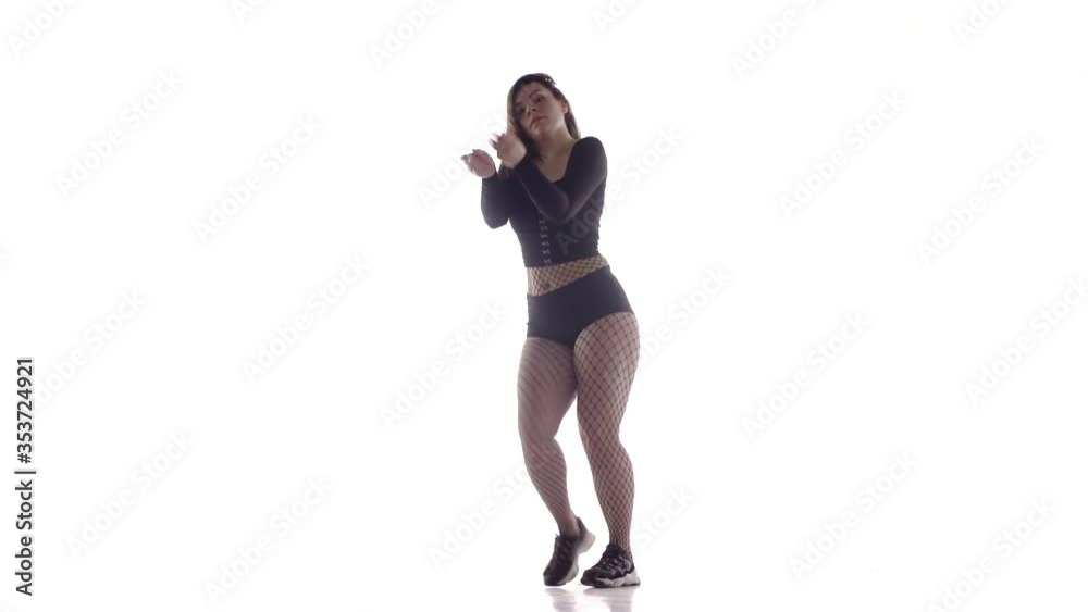 young beautiful girl dancer with long hair in fishnet tights and shorts dancing dancehall twerk, street modern dance, long shot, isolated young beautiful girl dancer with long hair in fishnet tights and shorts dancing dancehall twerk, street modern dance, long shot, isolated